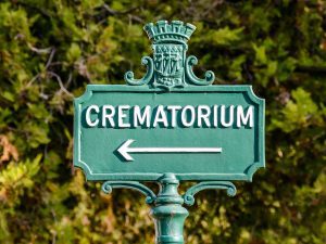 Signpost in green points to the crematorium